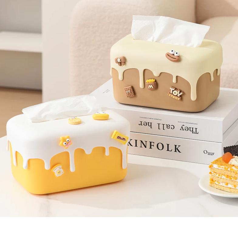 Elevate your home decor with our Cream Cake Tissue Box, a chic and creative storage solution perfect for any living room.