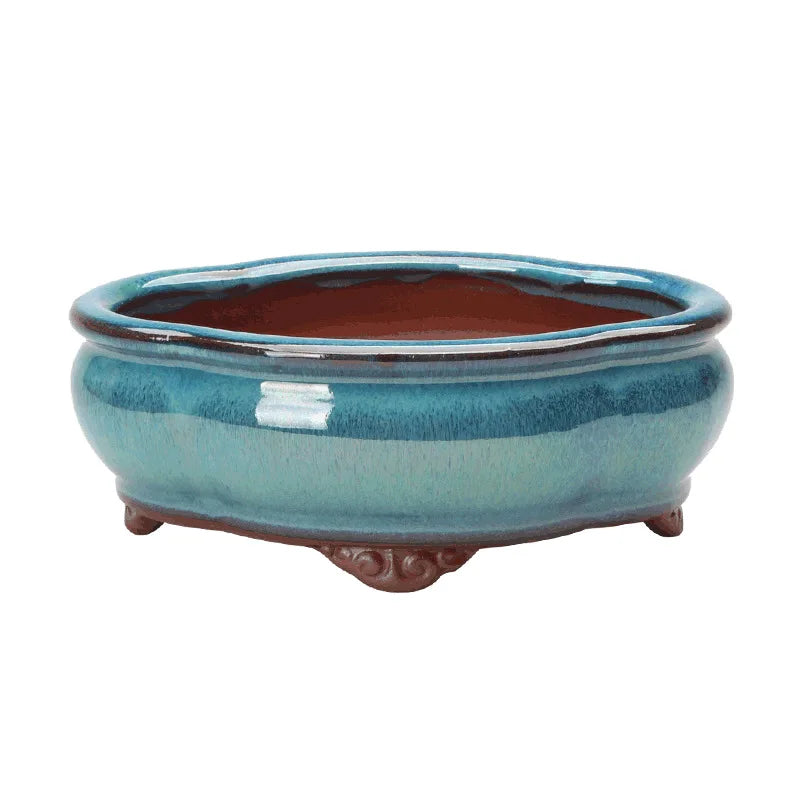 Enhance your space with the Creative Chinese Style Bonsai Flowerpot, a ventilated, elegant purple sands ceramic planter perfect for home or office greenery.