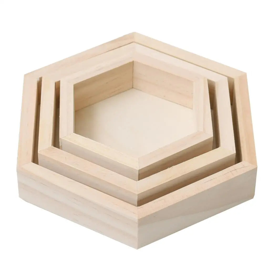 Set of three hexagonal wooden trays on a white background