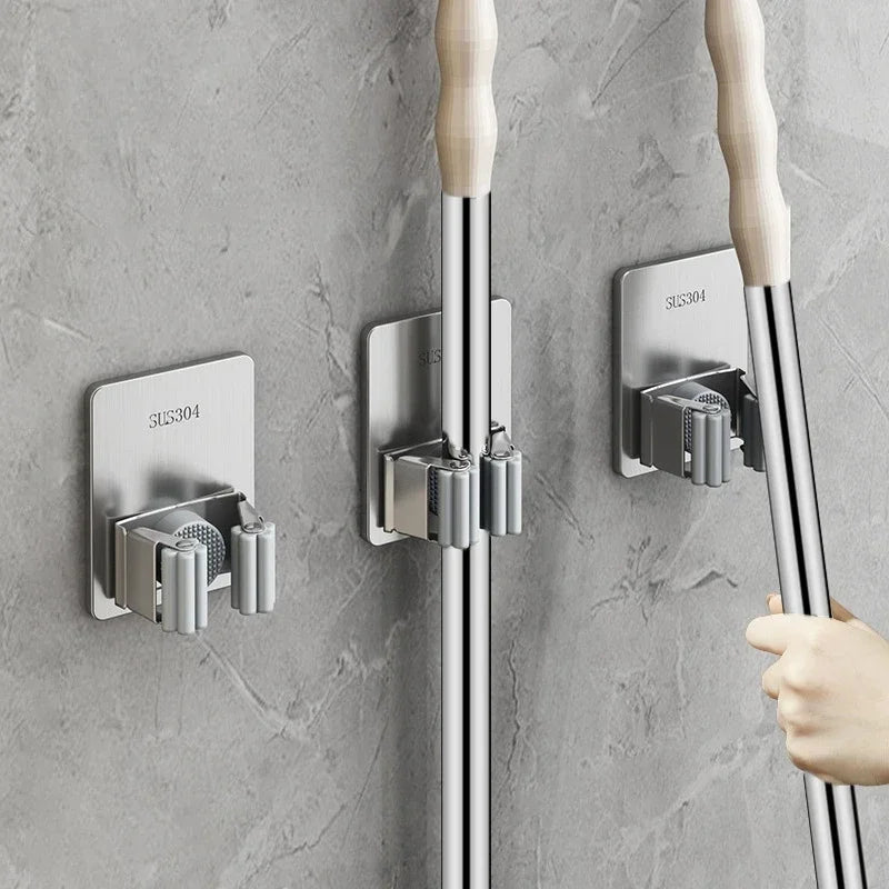 Wall-mounted mop organizer: Strong adhesive hooks for mops, brooms, and more. Durable 304 stainless steel with silica gel. Easy self-adhesive installation. Ideal for kitchen and bathroom organization.