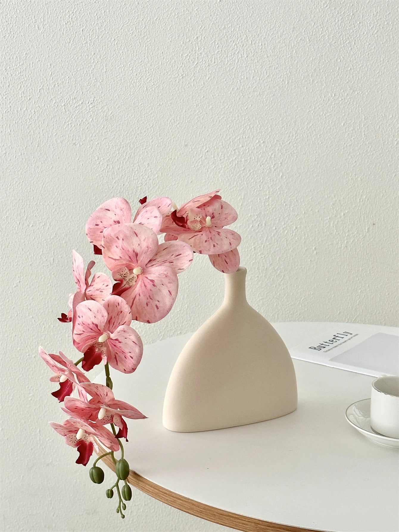 Enhance your home decor with high-end Phalaenopsis fake flowers, perfect for Mother's Day and any indoor setting.