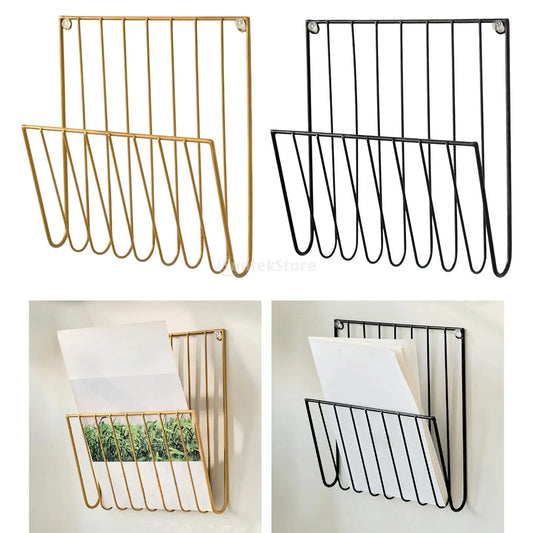 Two wall-mounted metal magazine racks, one gold and one black, with samples of magazines inside.