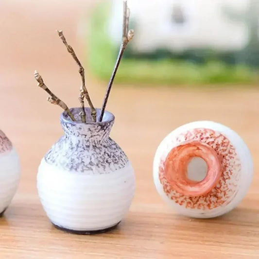 Elevate your decor with our Miniature Resin Small Mouth Vase, a durable and stylish accessory perfect for any space, available in six chic colors.