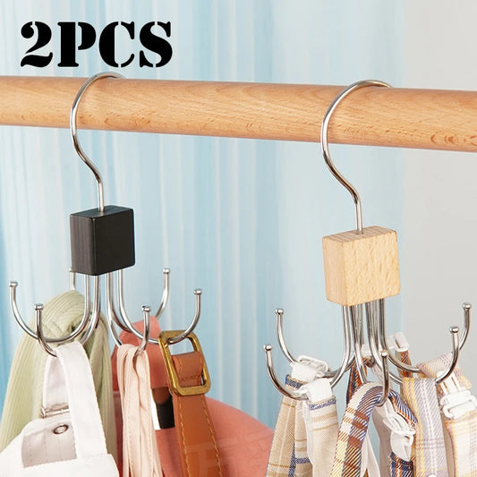 Two hanger organizers with multiple hooks on a wooden rod against a light blue curtain background.