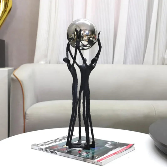 Cast Iron Sculpture: Creative black figure holding a silver ball for desktop decor, delivering timeless artistry and modern elegance that elevates—shop now