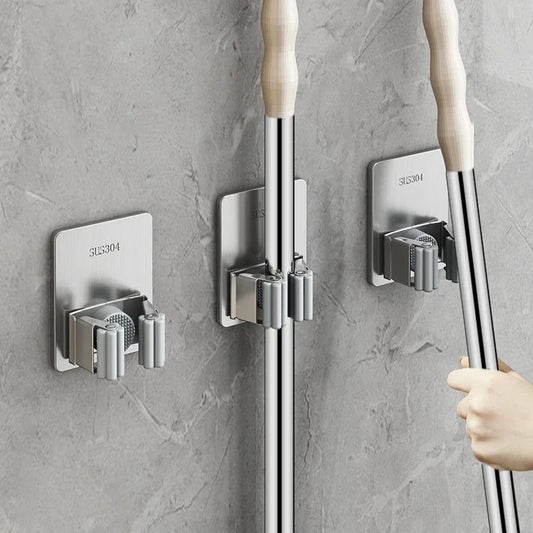 Wall-mounted mop organizer: Strong adhesive hooks for mops, brooms, and more. Durable 304 stainless steel with silica gel. Easy self-adhesive installation. Ideal for kitchen and bathroom organization.
