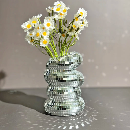 Add a touch of sparkle to your decor with our Disco Ball Spiral Glass Vase, featuring reflective tiles perfect for showcasing your favorite blooms.