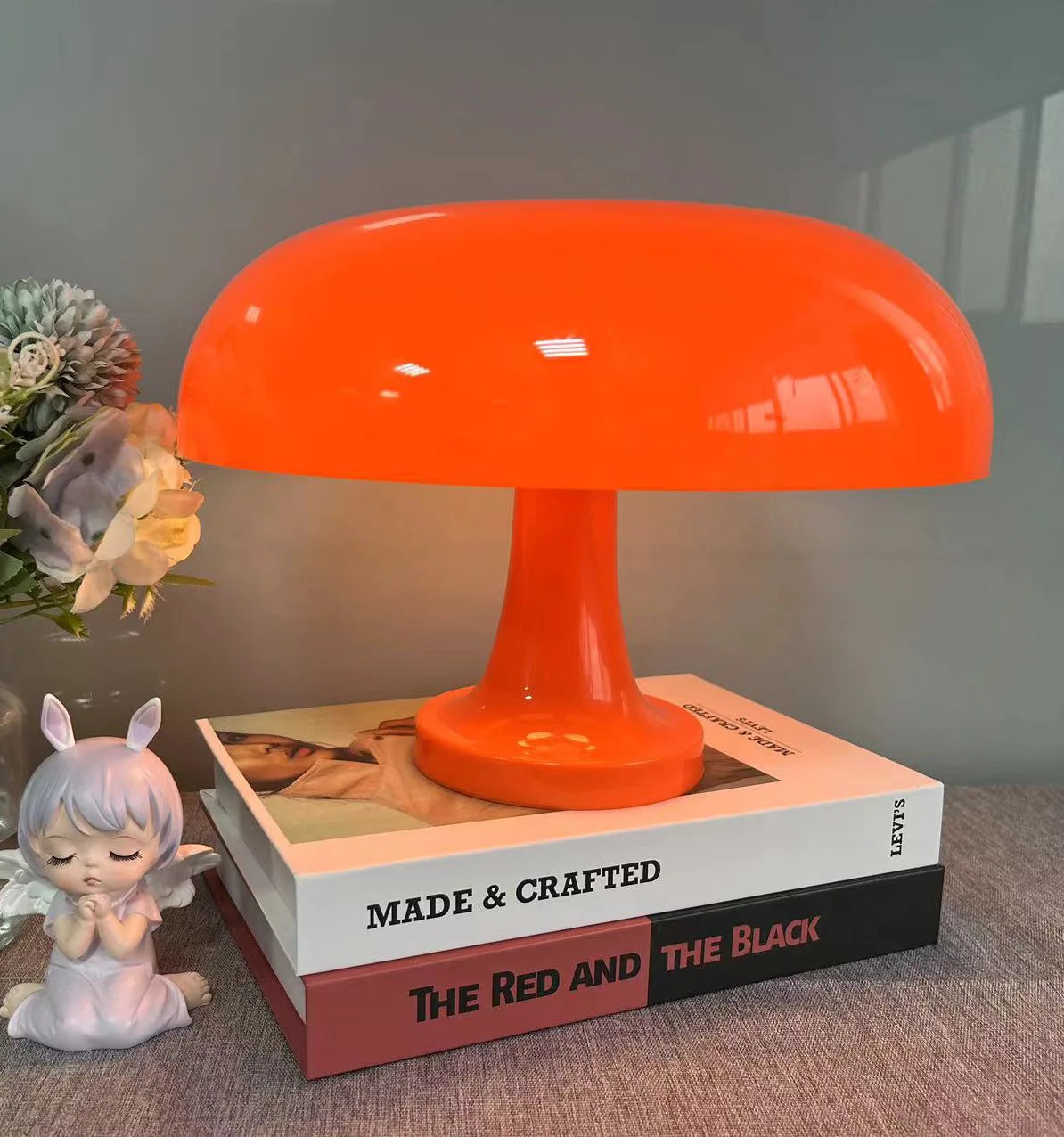 Illuminate your space with the Mushroom table lamp, a minimalist modern Danish designer orange bedside light perfect for a bohemian bedroom decor.
