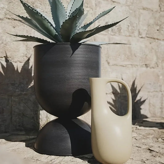 Rust-Resistant Iron Garden Planter delivers durable elegance with a distinctive irregular shape floor mounted versatility, and a bold black finish; Shop now.