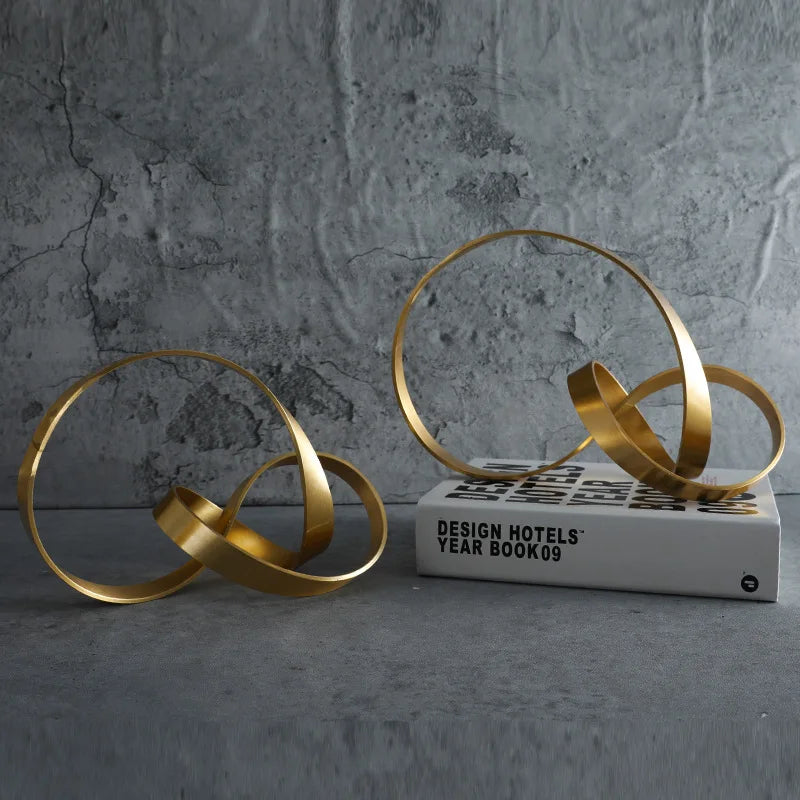 Elevate your space with the Gold Hollow Twist Art Ornament, a stunning modern metal decor piece perfect for living rooms and desks.